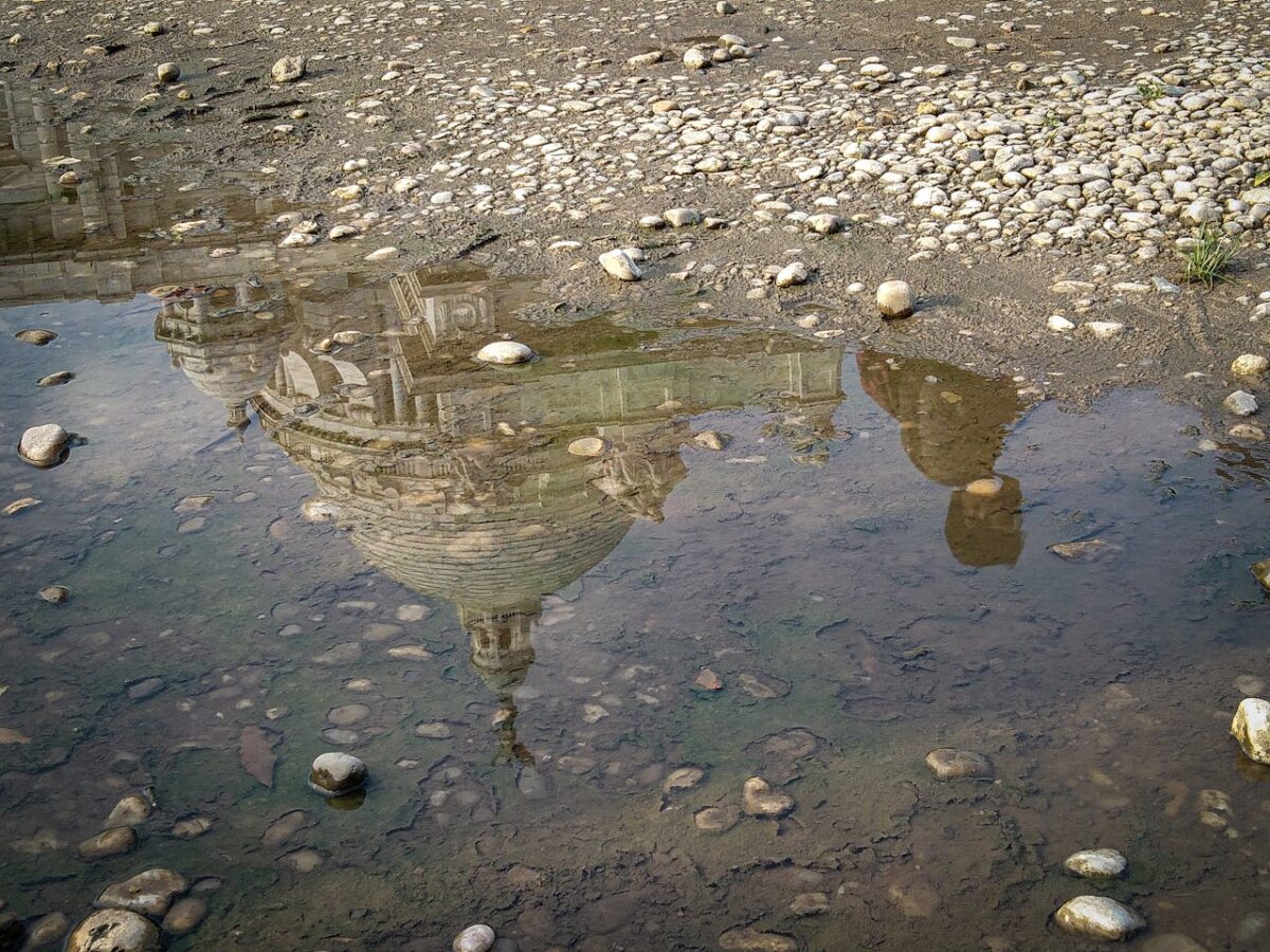 Artistic reflection of Victoria Memorial in a puddle after rain in Kolkata, India.